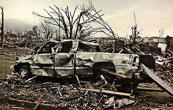 wrecked truck amid tornado damage in Joplin, Mo., in June 2011